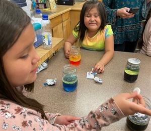 student noticing a change in smell, and wrinkled up her nose,  when the Alka Seltzer tablet was added